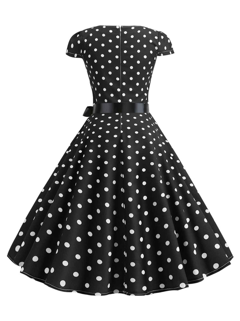 This 1950s Cap Sleeve Polka Dot Belted Dress wraps her in 1950s elegance, one twirl at a time
