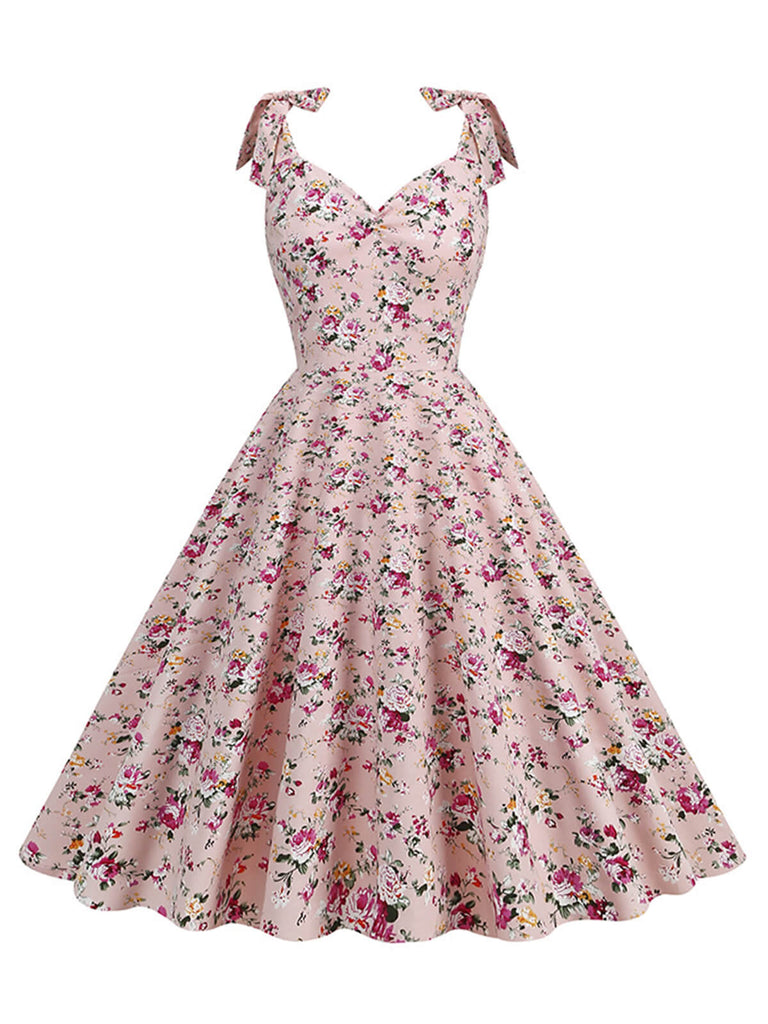 She slips into this 1950s Ditsy Floral Tie Swing Dress and suddenly it's a 1950s daydream