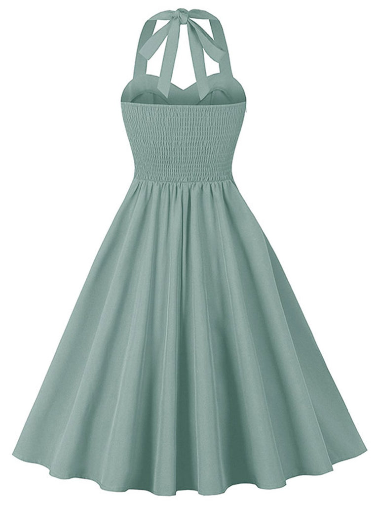 She slips into this 1950s Halter Pockets Backless Swing Dress and suddenly it's a 1950s daydream
