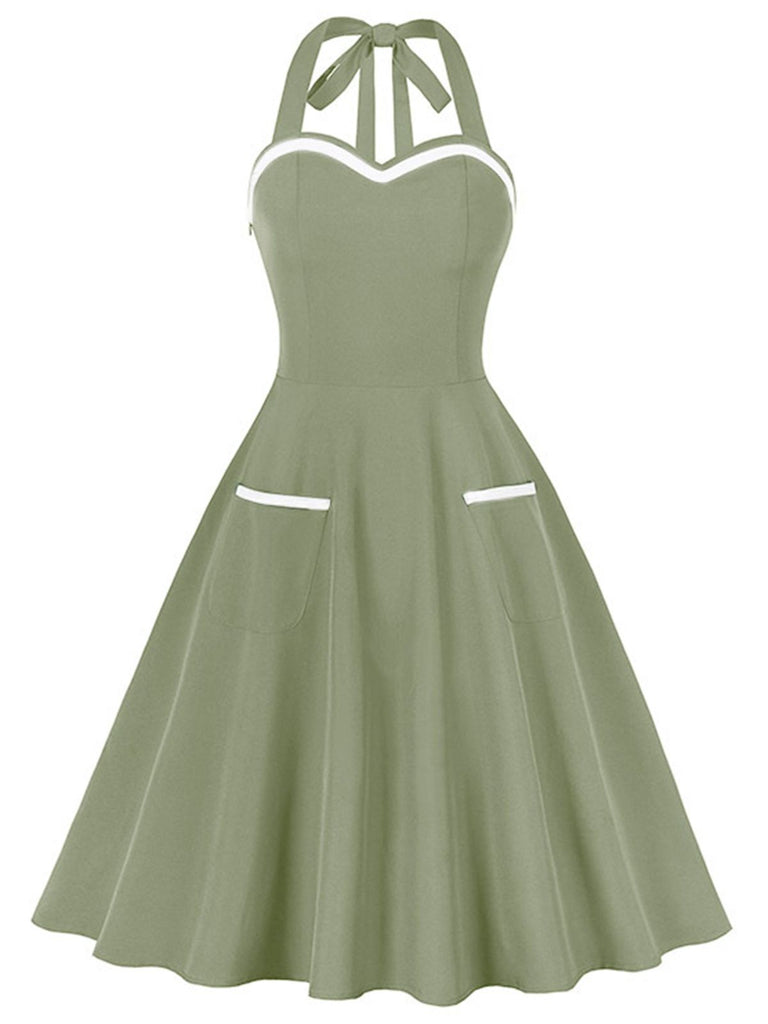 She slips into this 1950s Halter Pockets Backless Swing Dress and suddenly it's a 1950s daydream