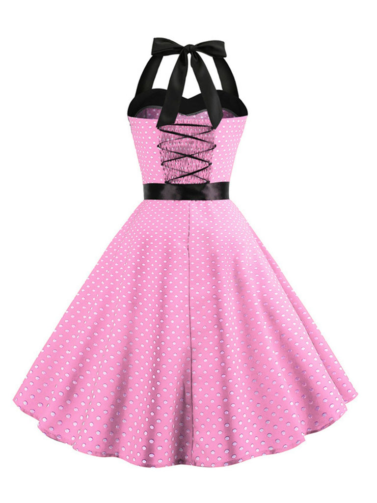 This 1950s Polka Dot Bow Tie Halter Swing Dress wraps her in 1950s elegance, one twirl at a time