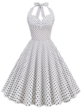 She slips into this 1950s Polka Dots Lace Up Halter Swing Dress and suddenly it's a 1950s daydream