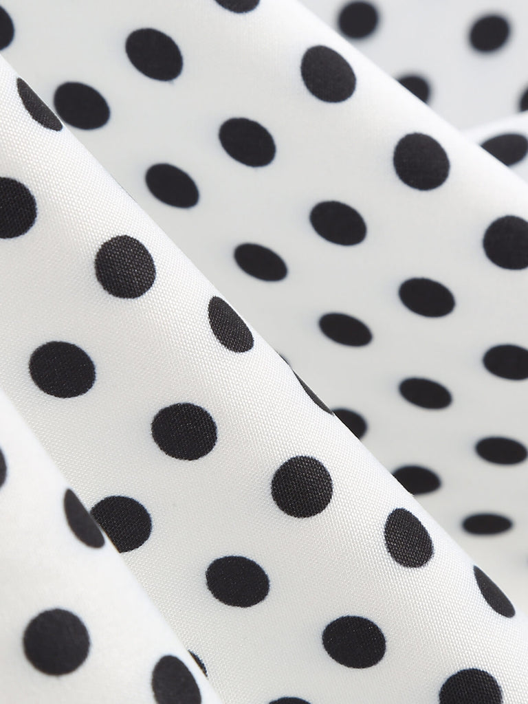 This 1950s Polka Dots Patchwork Ribbon Strap Dress wraps her in 1950s elegance, one twirl at a time