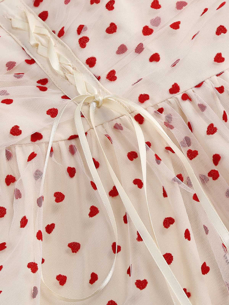 She slips into this 1950s Puff Sleeve Valentine Heart Mesh Dress and suddenly it's a 1950s daydream