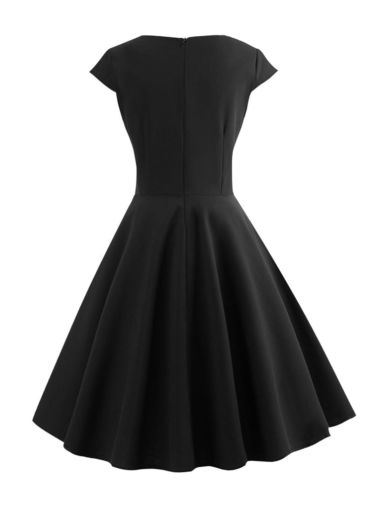 She slips into this 1950s Solid Heart Neck Short Sleeve Dress and suddenly it's a 1950s daydream