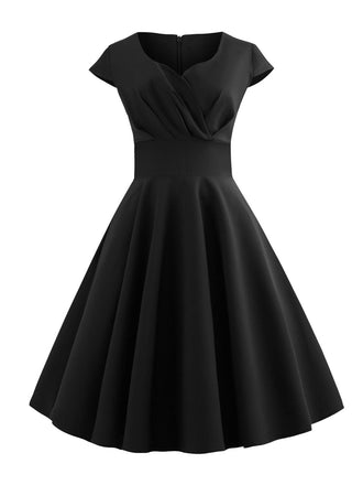 She slips into this 1950s Solid Heart Neck Short Sleeve Dress and suddenly it's a 1950s daydream