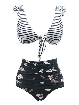 She's wearing 1970s Strap Stripes Floral Swimsuit and the whole beach remembers the 1970s