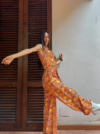 She adds this 1970s V-Neck Floral Belted Sleeveless Jumpsuit and suddenly it's 1970s perfection