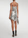 She pairs this 2PCS Silver 1980s Sequined Suspender Tassel Top & Skirt with confidence and 1980s charm