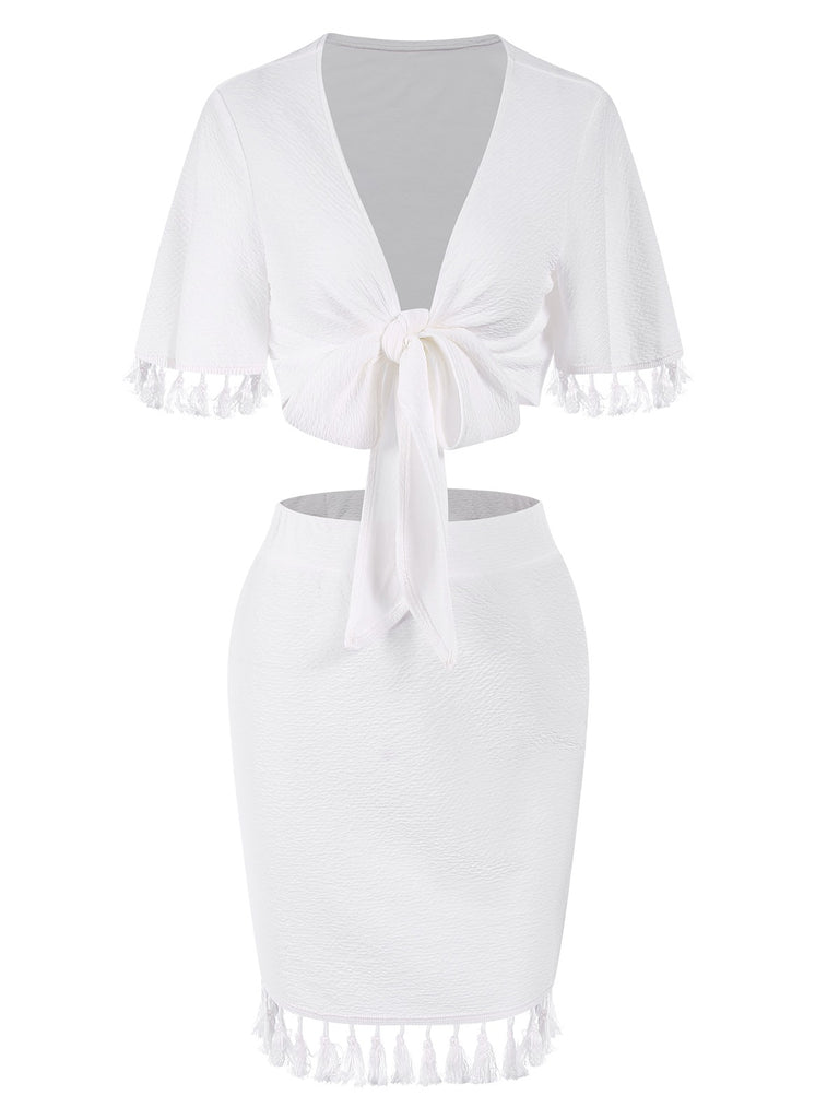 She pairs this 2PCS White 1960s Solid Tassels Bind Top & Pencil Skirt with confidence and 1960s charm
