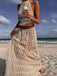 She pairs this 2PCS White 1970s Wrinkle Halter Backless Top & Skirts with confidence and 1970s charm