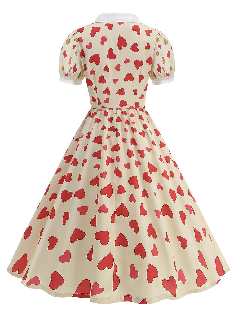 This Beige 1950s Hearts Puff Sleeves Lapel Dress wraps her in 1950s elegance, one twirl at a time
