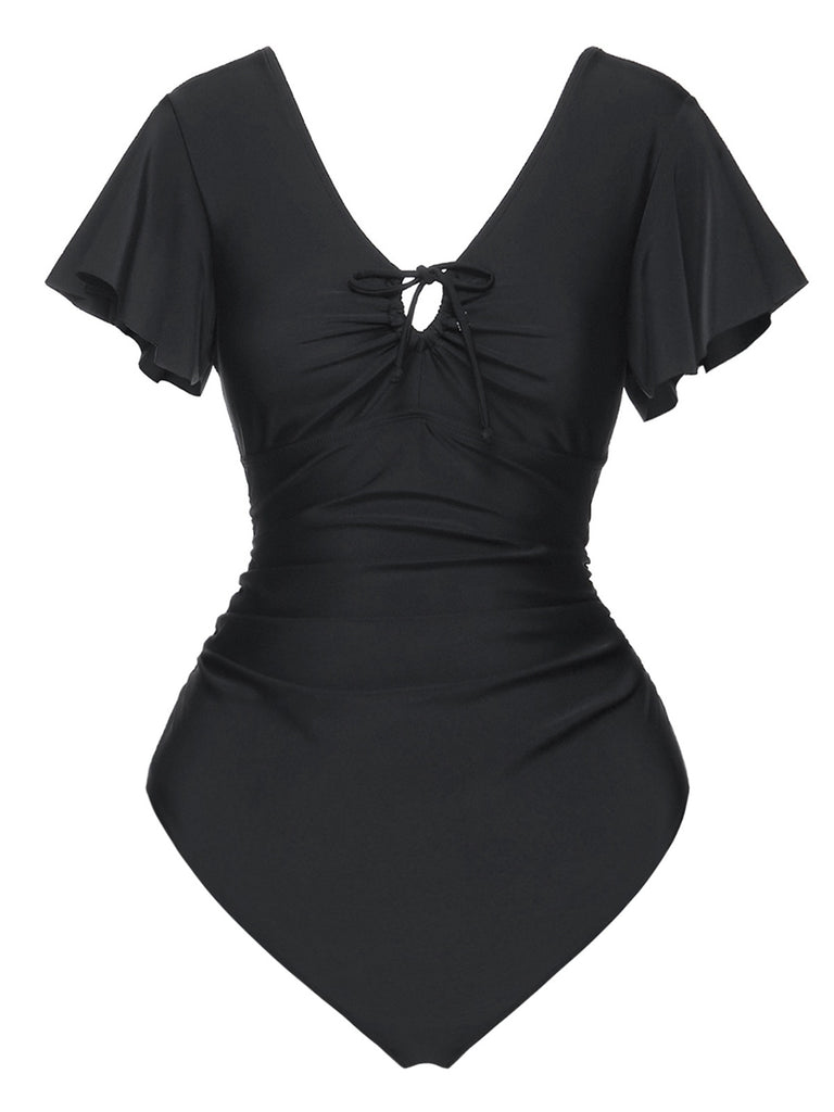 She's wearing Black 1940s Solid Ruffle Sleeves One-Piece Swimsuit and the whole beach remembers the 1940s