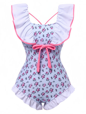 She's wearing Blue 1950s Ditsy Floral Bow Ruffled Swimsuit and the whole beach remembers the 1950s