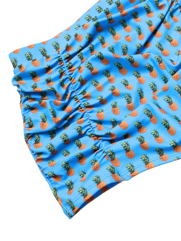 She's wearing Blue 1950s Pineapple Strap Bow Swimsuit and the whole beach remembers the 1950s