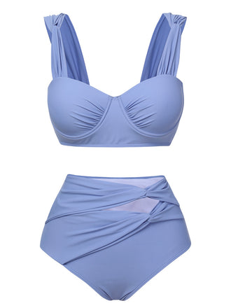 She's wearing Blue Grey 1960s Wide Strap Wrinkle Swimsuit and the whole beach remembers the 1960s