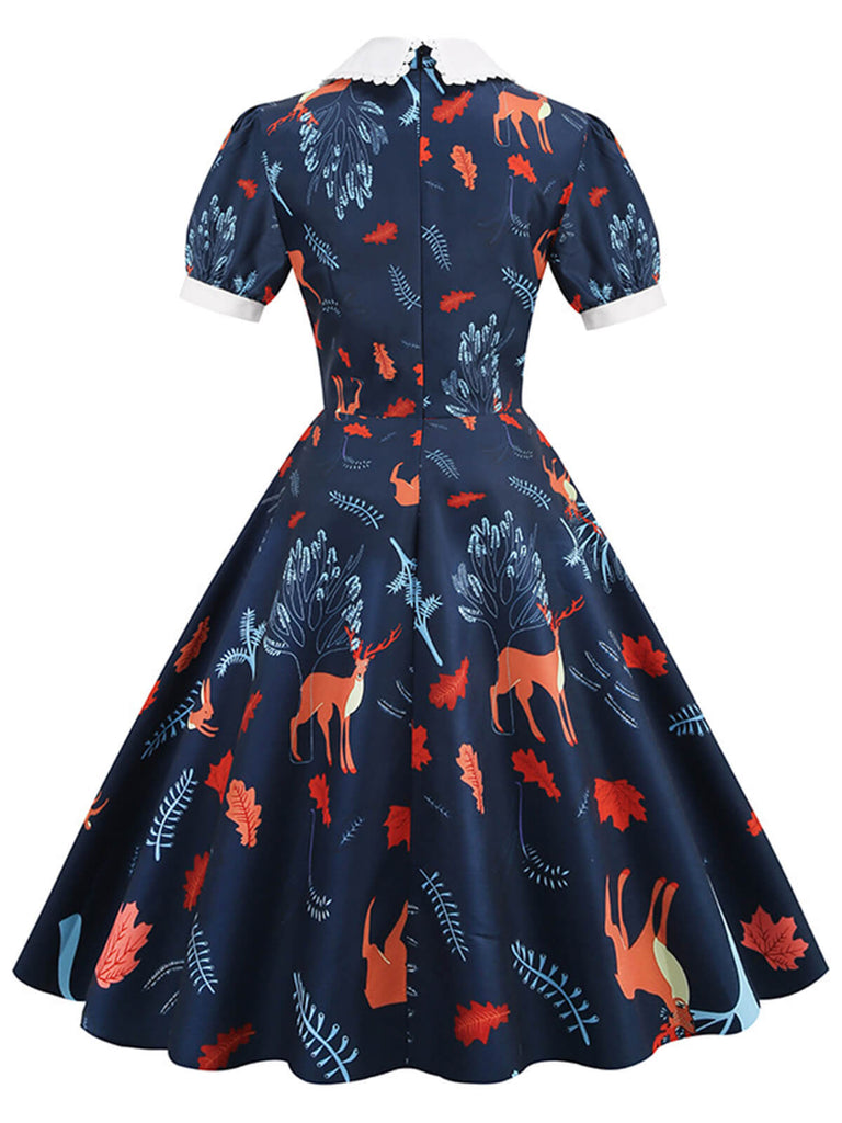 This Dark Blue 1950s Forest Puff Lapel Dress wraps her in 1950s elegance, one twirl at a time
