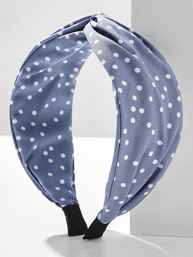 She finds her vintage story in this Fabric Wide Brim Polka Dot Cross Headband