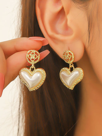 She adds this Gold Heart Pearl Drop Earrings and suddenly it's vintage perfection