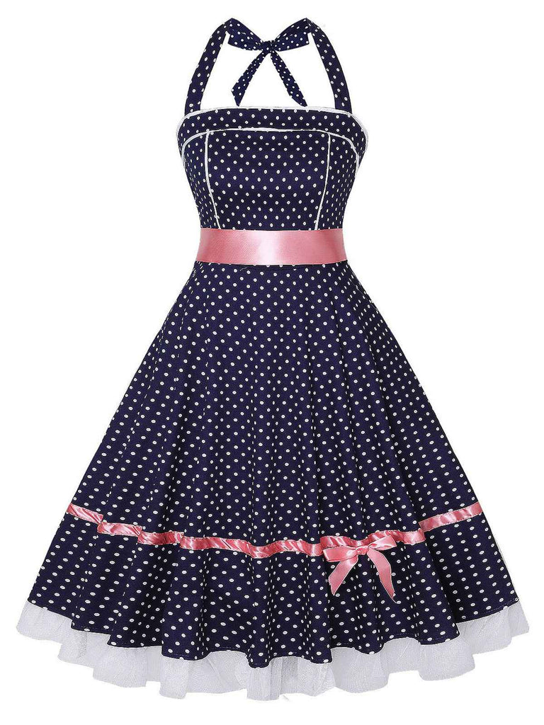 She slips into this Navy Blue 1950s Polka Dot Halter Dress and suddenly it's a 1950s daydream