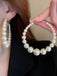 She adds this Pearl Large Hoop Vintage Earrings and suddenly it's 1950s perfection