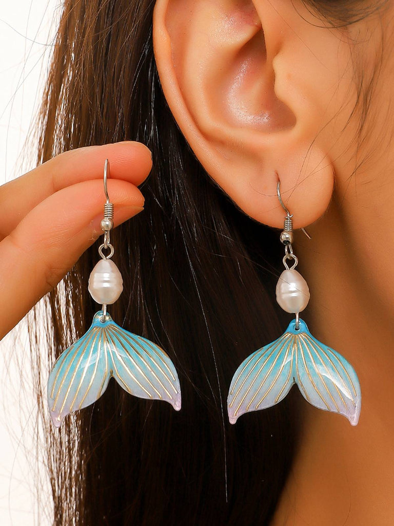 She adds this Mermaid Tail Seashell Dangle Earrings and suddenly it's vintage perfection