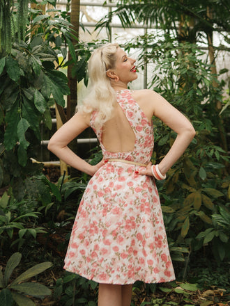 She slips into this Pink 1950s Floral V-Neck Dress and suddenly it's a 1950s daydream