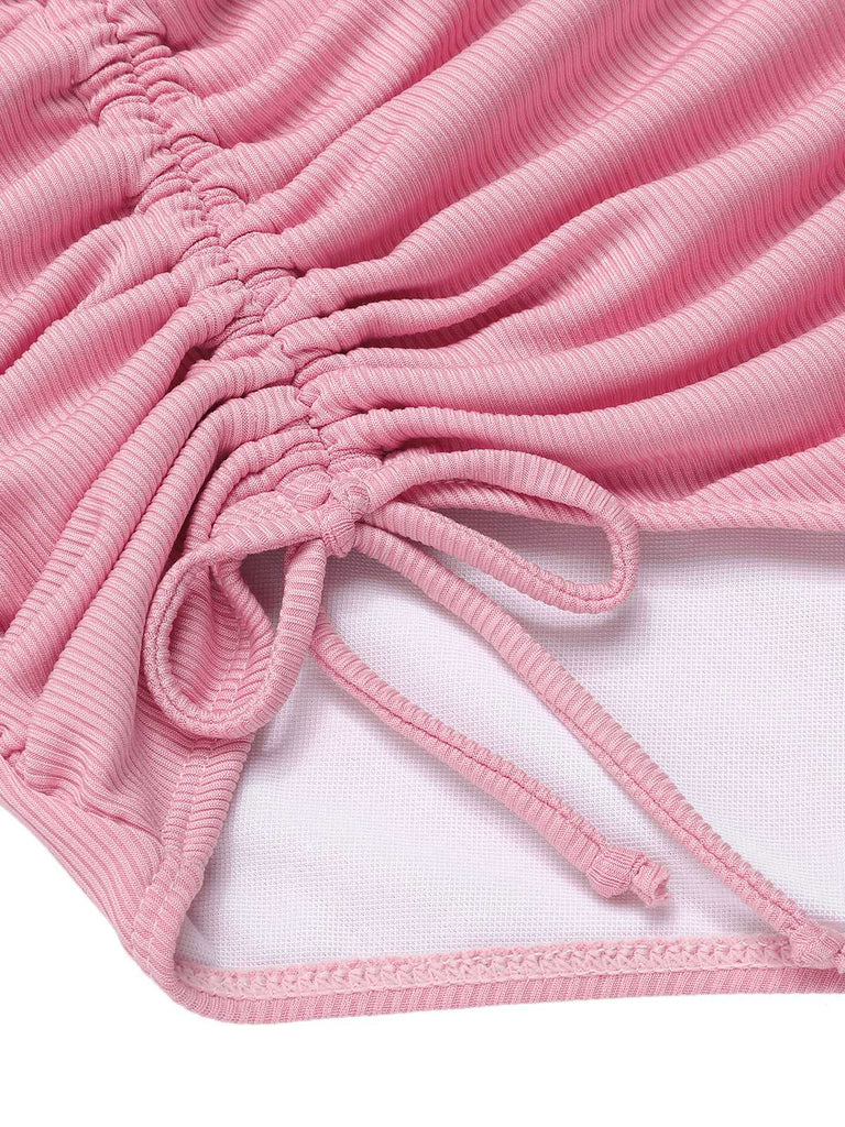 She's wearing Pink 1950s Halter Pleated Solid One-Piece Swimsuit and the whole beach remembers the 1950s