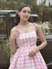This Pink 1950s Spaghetti Strap Plaid Swing Dress wraps her in 1950s elegance, one twirl at a time