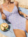 She's wearing Purple 1950s Ditsy Floral Lace-Up One-Piece Swimsuit and the whole beach remembers the 1950s