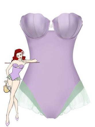 She's wearing Purple 1970s Shell Mermaid Bandeau One-Piece Swimsuit and the whole beach remembers the 1970s
