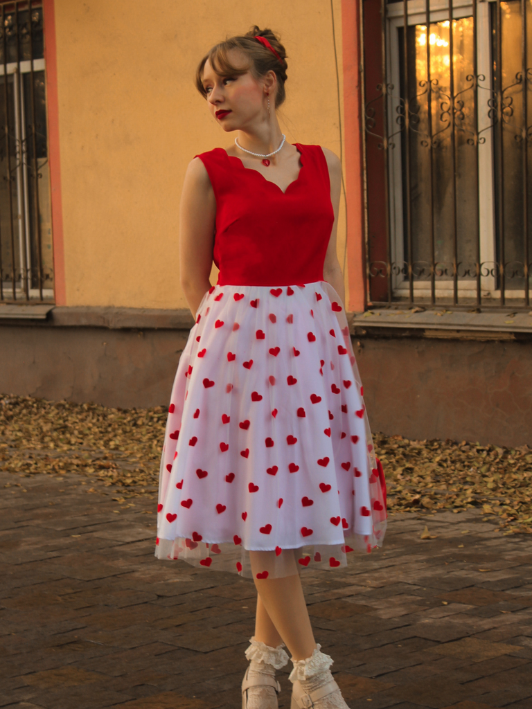 She slips into this Red 1950s Heart Bow Sleeveless Dress and suddenly it's a 1950s daydream