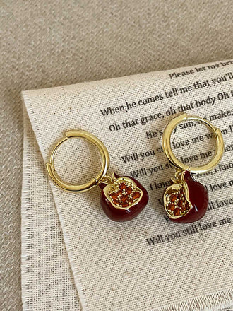 She adds this Red Pomegranate Charm Earrings and suddenly it's vintage perfection