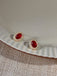 She adds this Red Vintage Oval Crystal Diamond Earrings and suddenly it's 1950s perfection
