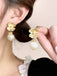 She adds this Retro Alloy Flower Pearl Earrings and suddenly it's 1950s perfection