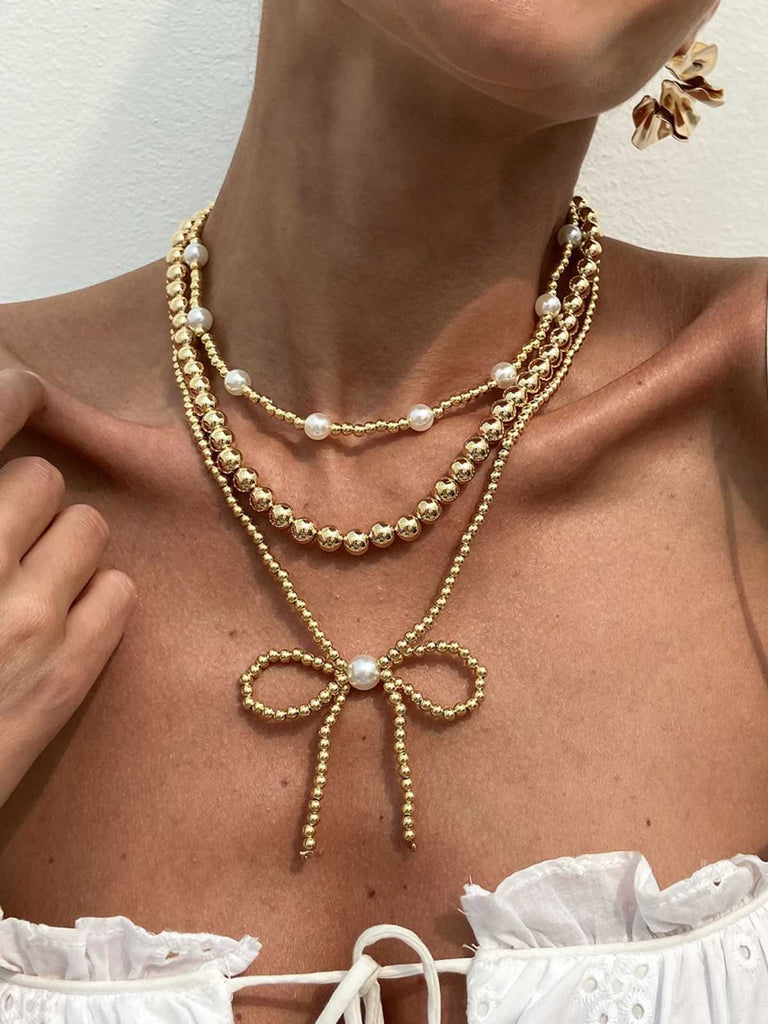 She adds this Retro Beads Bow Layered Necklace and suddenly it's 1950s perfection
