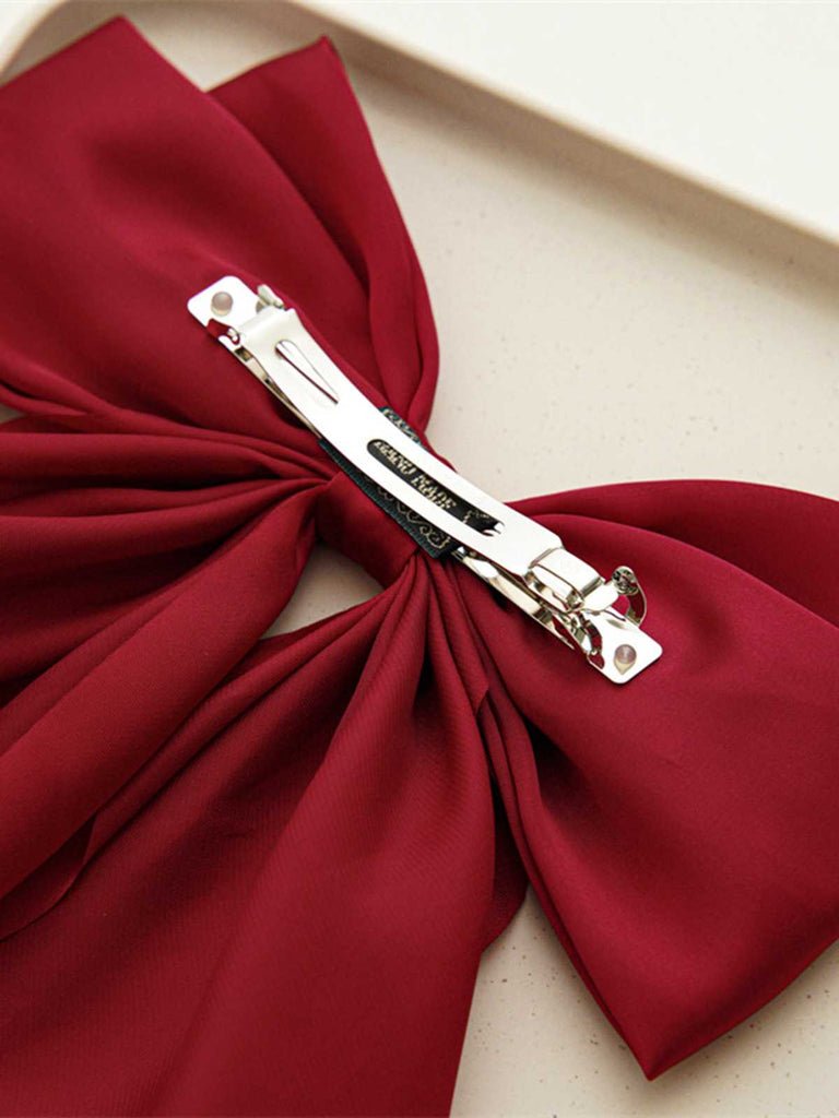 This Satin Ribbon Solid Bow Hairpin whispers vintage secrets to those who notice