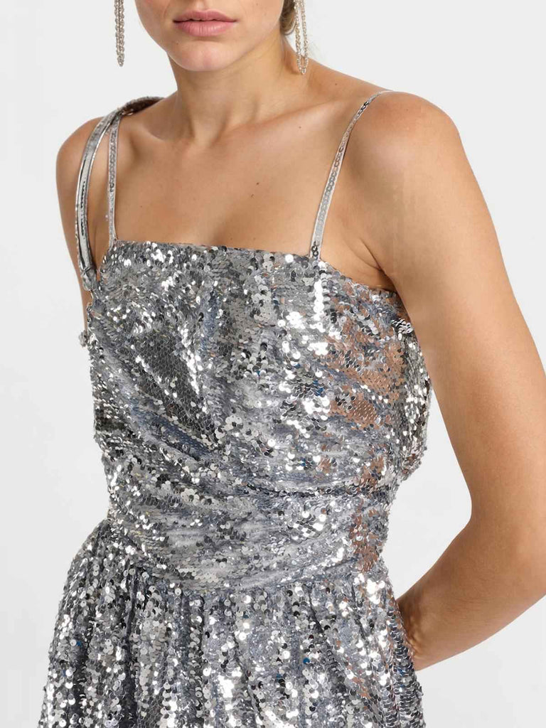 This Silver 1970s Spaghetti Straps Sequined Tutu Dress wraps her in 1970s elegance, one twirl at a time
