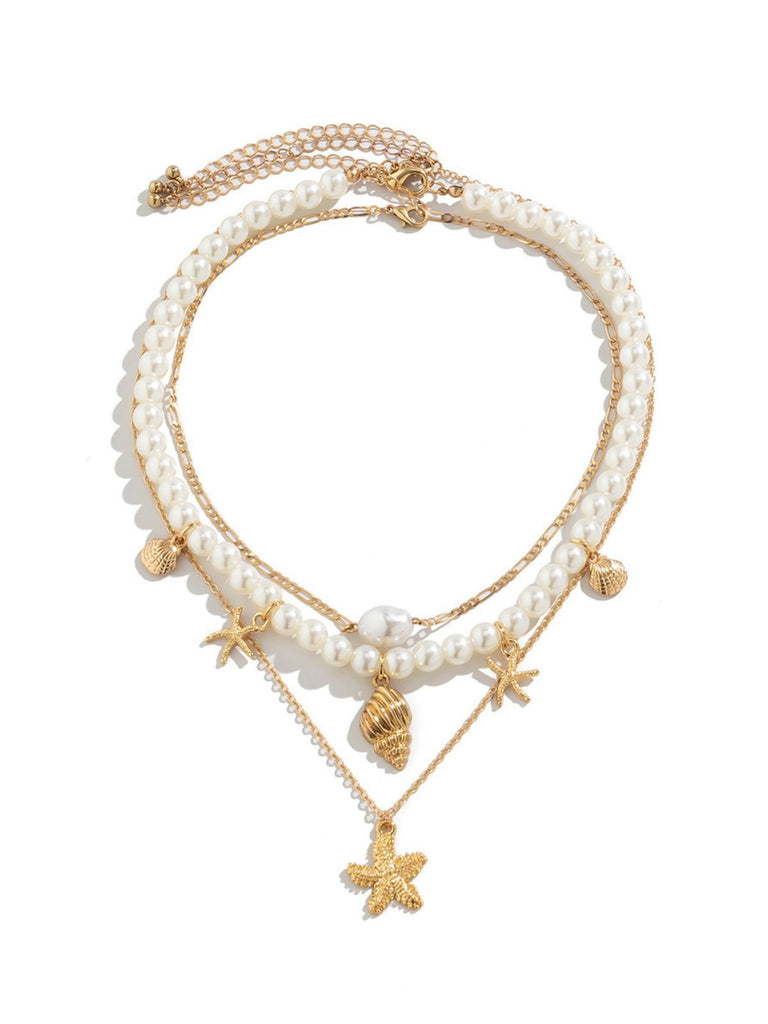 She adds this Starfish Seashell Pearl Layered Chain Necklace and suddenly it's vintage perfection