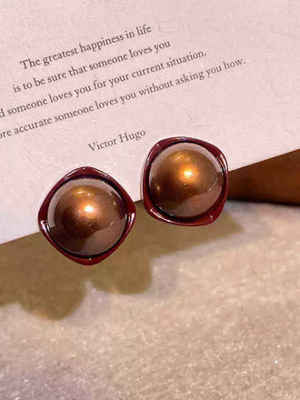 She adds this Vintage Brown Dome Glossy Earrings and suddenly it's 1950s perfection