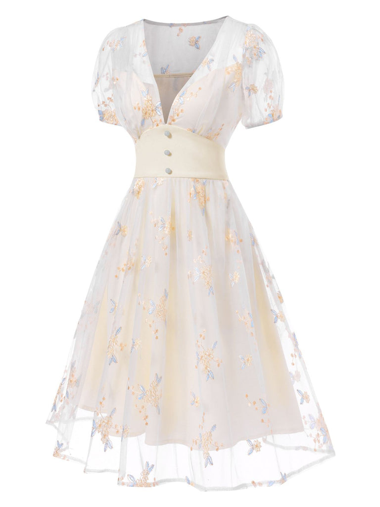 This White 1950s Deep V-Neck Embroidered Floral Dress wraps her in 1950s elegance, one twirl at a time