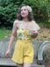 She finds her 1950s story in this Yellow 1950s Sunflower Halter Romper