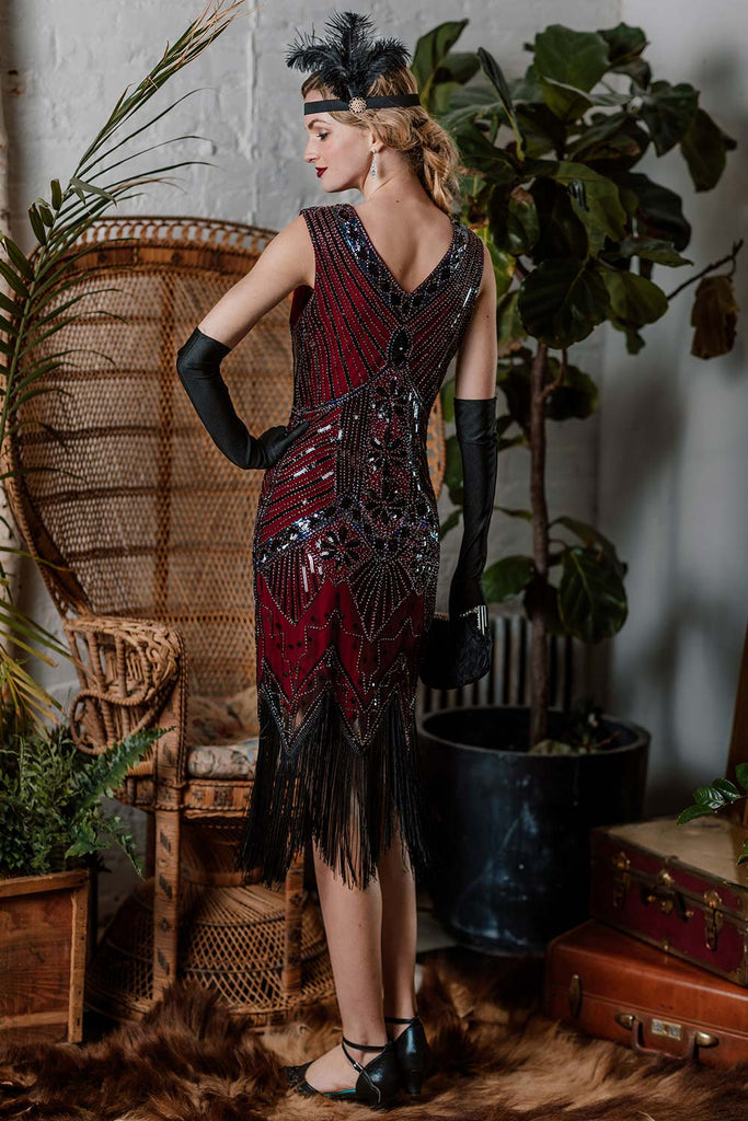 This 1920s Sequined Fringe Dress wraps her in 1920s elegance, one twirl at a time